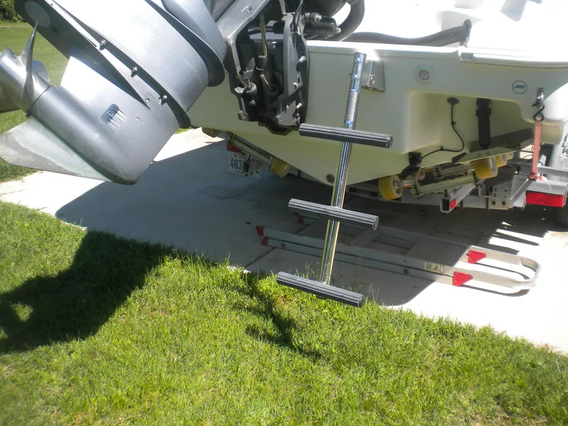 Slide: The Image of 2003 Pro-Line 23 Walk boat with ladder and motor on a trailer. - 7
