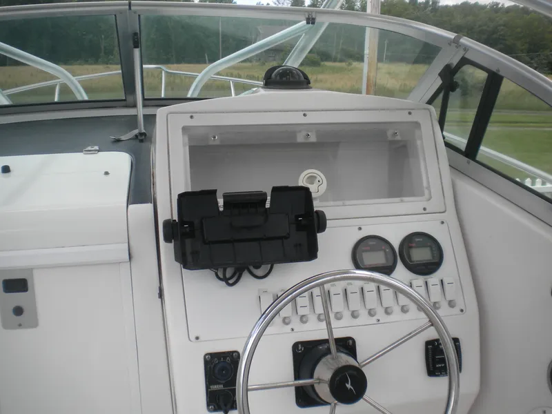 Slide: The Image of 2003 Pro-Line 23 Walk boat dashboard with steering wheel and instrument panel. - 9