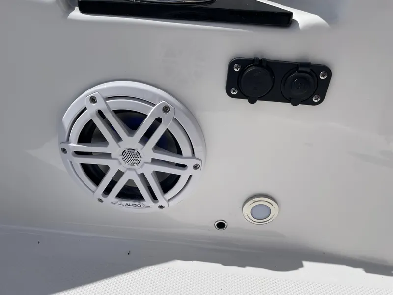 Slide: The Image of 2024 Blackfin 232DC boat speaker and electrical outlets on white panel. - 21