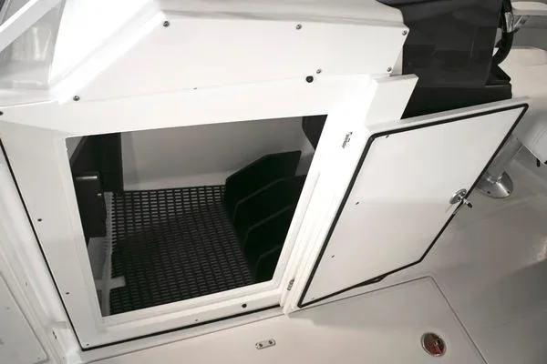 Slide: The Image of 2024 Blackfin 232DC boat storage compartment with open door, showcasing interior space. - 48