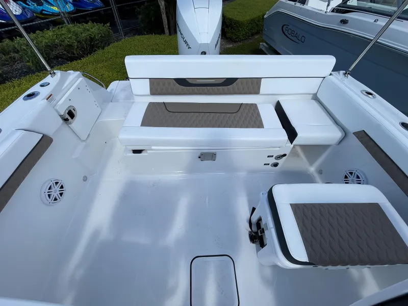 Slide: The Image of 2024 Blackfin 232DC boat interior with white seating and brown accents. - 7