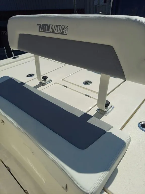 Slide: The Image of 2023 Pathfinder 2300 HPS boat seating with logo, featuring white and gray upholstery. - 13