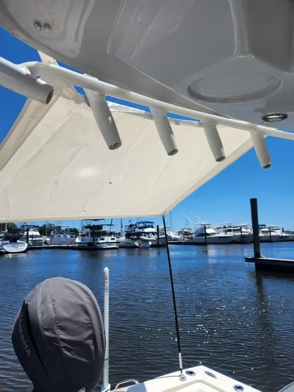 Slide: The Image of 2023 Pathfinder 2300 HPS boat docked at marina under clear blue sky. - 14
