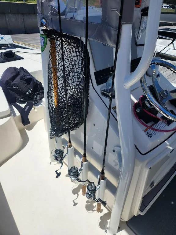 Slide: The Image of 2023 Pathfinder 2300 HPS boat interior with fishing rods and net. - 17