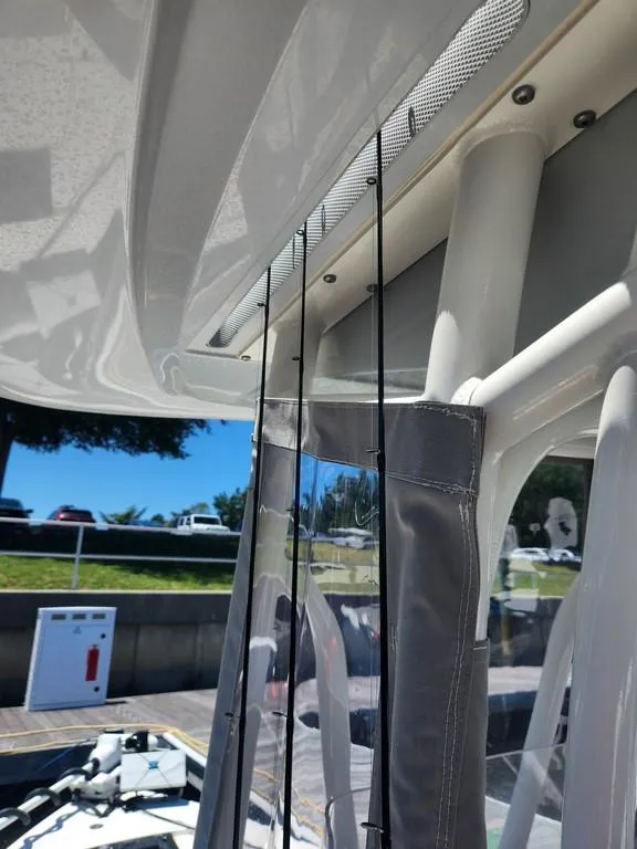 Slide: The Image of 2023 Pathfinder 2300 HPS boat interior with fishing rod holders and canopy. - 19