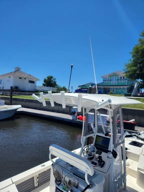 Slide: The Image of 2023 Pathfinder 2300 HPS boat docked under clear blue sky. - 28
