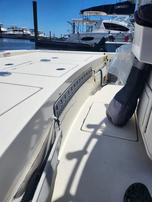 Slide: The Image of 2023 Pathfinder 2300 HPS boat docked, showcasing deck and seating area. - 30