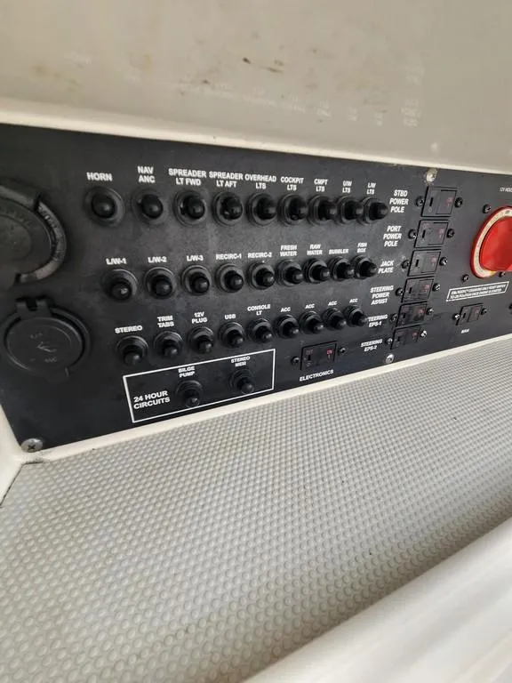 Slide: The Image of Control panel of 2023 Pathfinder 2300 HPS boat with various switches and indicators. - 34