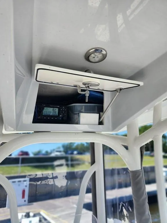 Slide: The Image of 2023 Pathfinder 2300 HPS boat console with storage compartment and electronic display. - 39