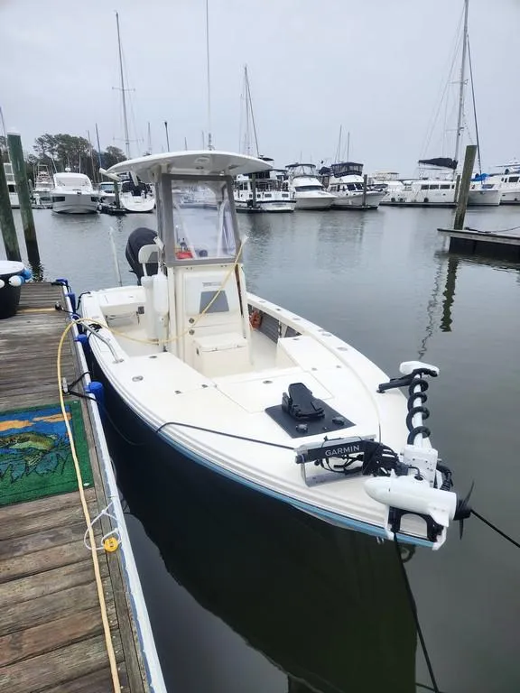 Slide: The Image of 2023 Pathfinder 2300 HPS boat docked at a marina with other vessels. - 4