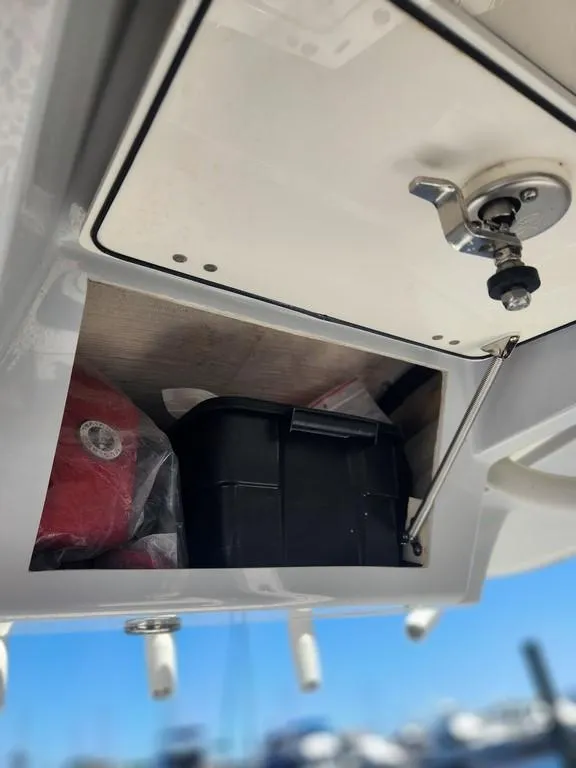 Slide: The Image of 2023 Pathfinder 2300 HPS storage compartment with latch, containing a black box and red item. - 40