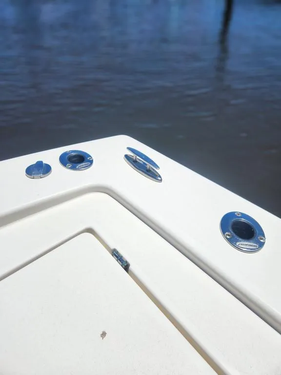 Slide: The Image of 2023 Pathfinder 2300 HPS boat deck with rod holders and water in background. - 43