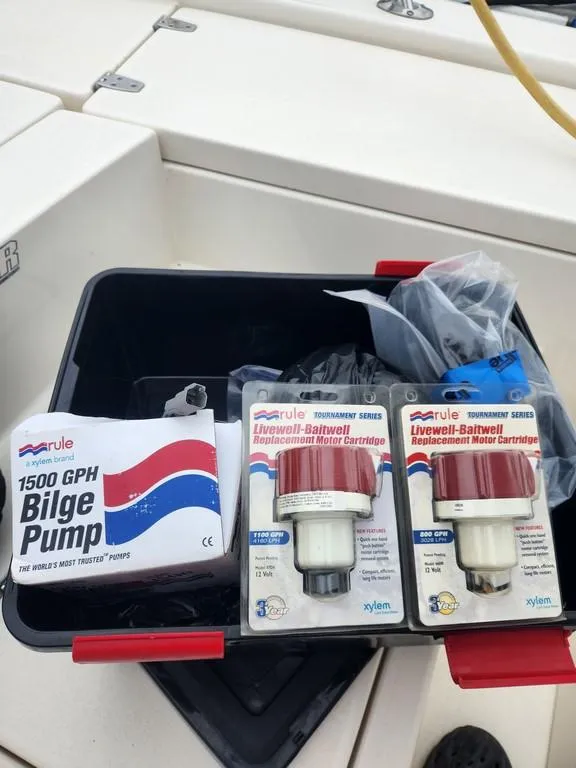 Slide: The Image of Boat accessories including Rule bilge pump and motor cartridges on a 2023 Pathfinder 2300 HPS. - 48