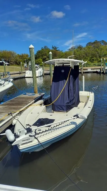 Slide: The Image of 2023 Pathfinder 2300 HPS boat docked at a marina under a clear blue sky. - 5