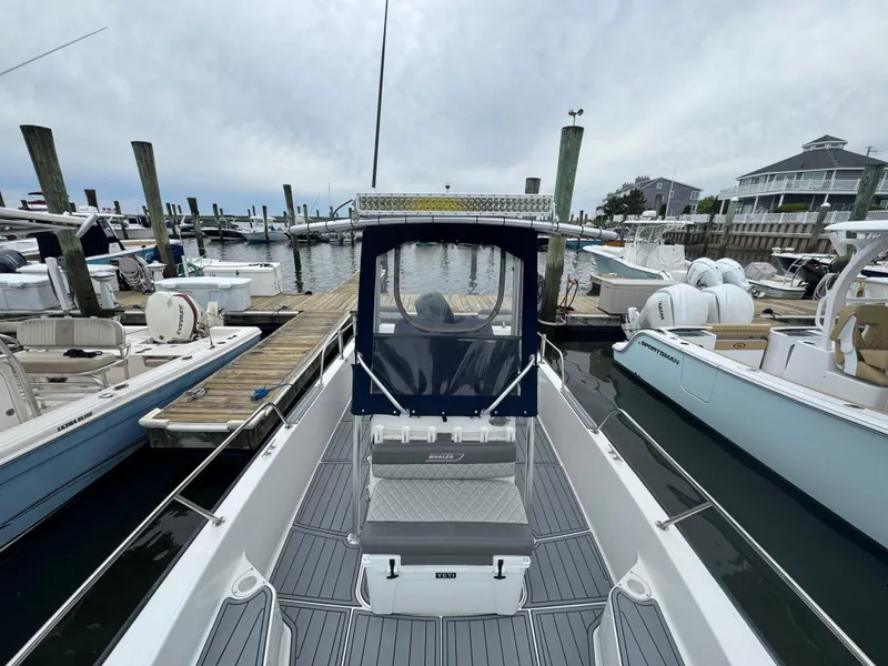 Slide: The Image of 2013 Boston Whaler 210 Montauk docked at marina, surrounded by other boats. - 14