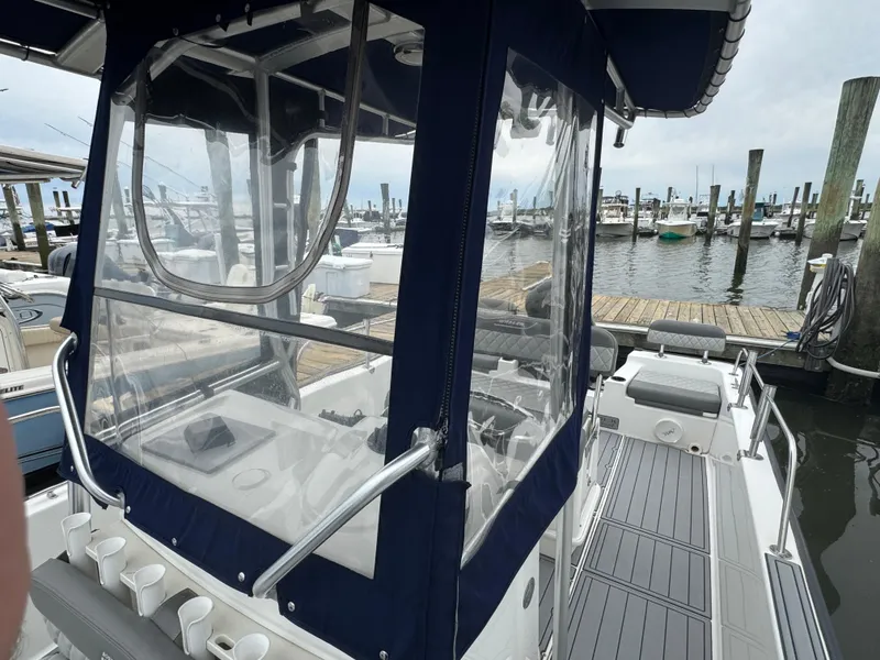 Slide: The Image of Boston Whaler 210 Montauk 2013 boat docked at marina with clear enclosure. - 22