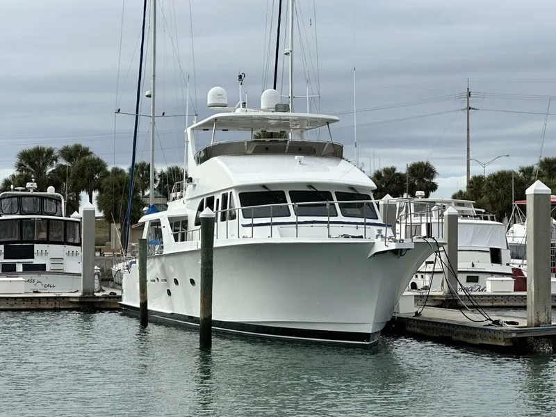 Slide: The Image of 2004 Cheoy Lee 72 yacht docked at marina under cloudy skies. - 11