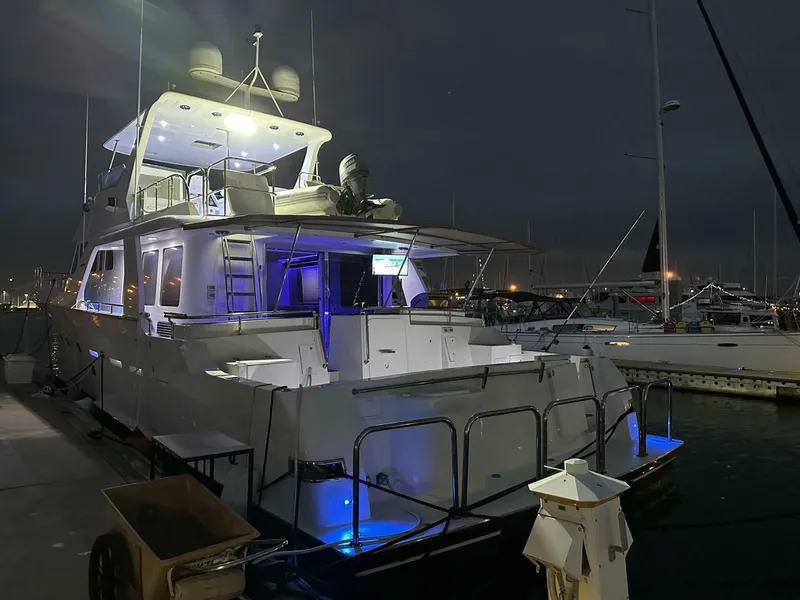 Slide: The Image of 2004 Cheoy Lee 72 yacht docked at night with illuminated deck lights. - 14