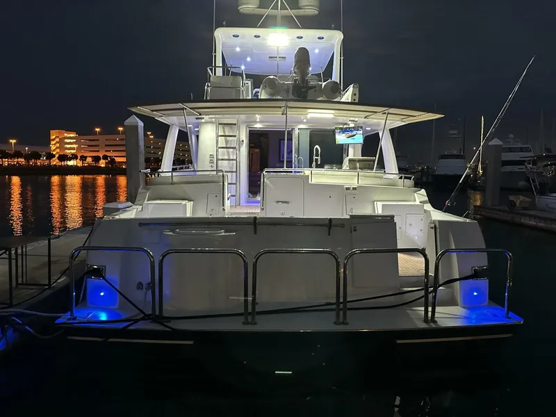 Slide: The Image of 2004 Cheoy Lee 72 yacht docked at night with illuminated deck and marina view. - 17
