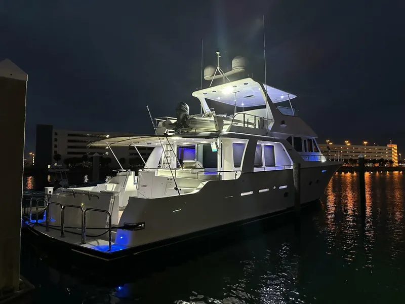 Slide: The Image of Luxurious 2004 Cheoy Lee 72 yacht illuminated at night, docked in a serene marina. - 19