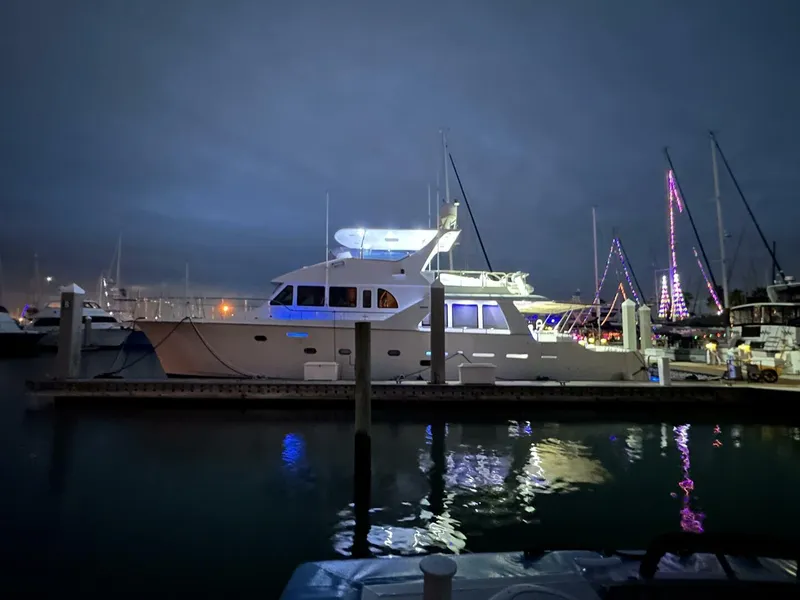 Slide: The Image of 2004 Cheoy Lee 72 yacht illuminated at night in a marina setting. - 22