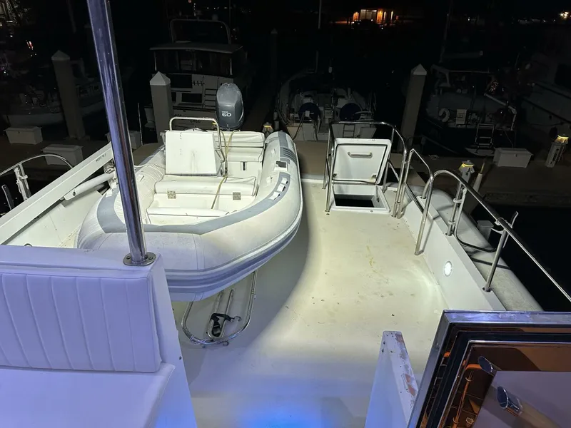Slide: The Image of 2004 Cheoy Lee 72 yacht deck with inflatable boat at night. - 26