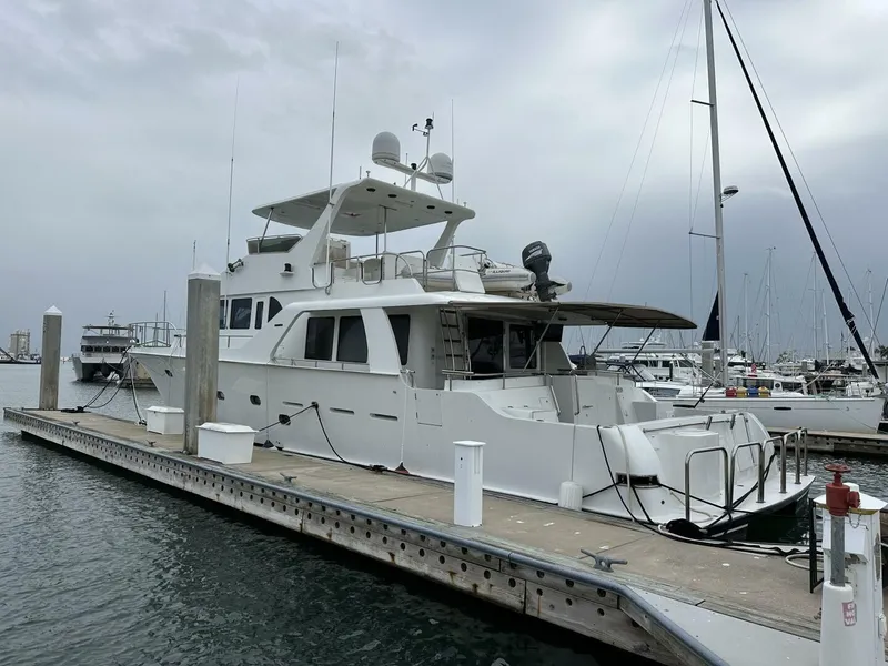 Slide: The Image of 2004 Cheoy Lee 72 yacht docked at marina under cloudy sky. - 27