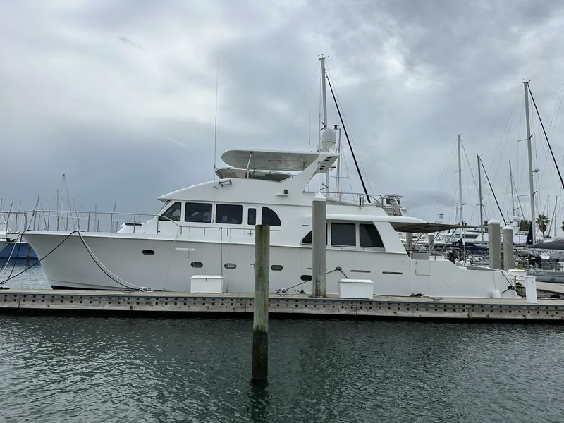 Slide: The Image of 2004 Cheoy Lee 72 yacht docked at marina under cloudy sky. - 28