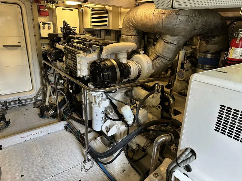 Slide: The Image of Engine room of a 2004 Cheoy Lee 72 yacht, featuring complex machinery and equipment. - 30
