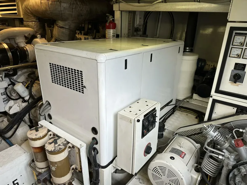 Slide: The Image of Engine room of 2004 Cheoy Lee 72 yacht, featuring machinery and control panels. - 32