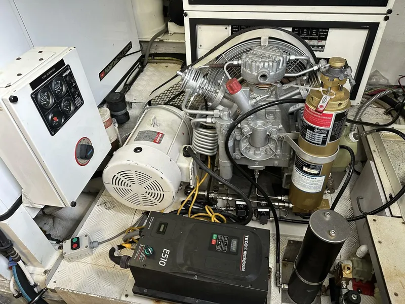 Slide: The Image of Engine room of a 2004 Cheoy Lee 72 yacht, featuring mechanical components and control panels. - 35