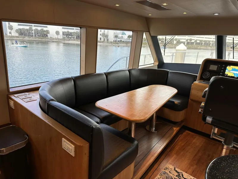 Slide: The Image of Luxurious interior of 2004 Cheoy Lee 72 yacht with leather seating and wooden table. - 48