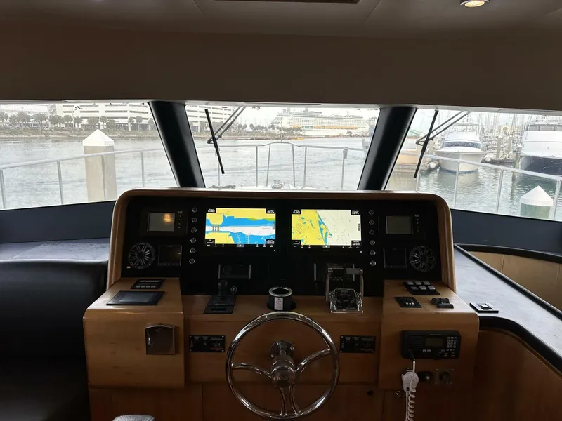 Slide: The Image of Helm of 2004 Cheoy Lee 72 yacht with navigation screens and steering wheel. - 49