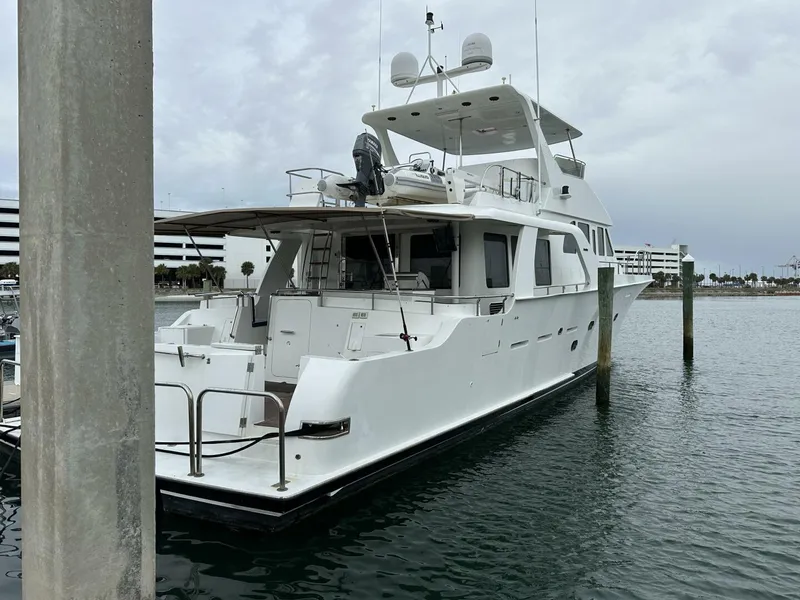 Slide: The Image of 2004 Cheoy Lee 72 yacht docked in a marina, overcast sky. - 5