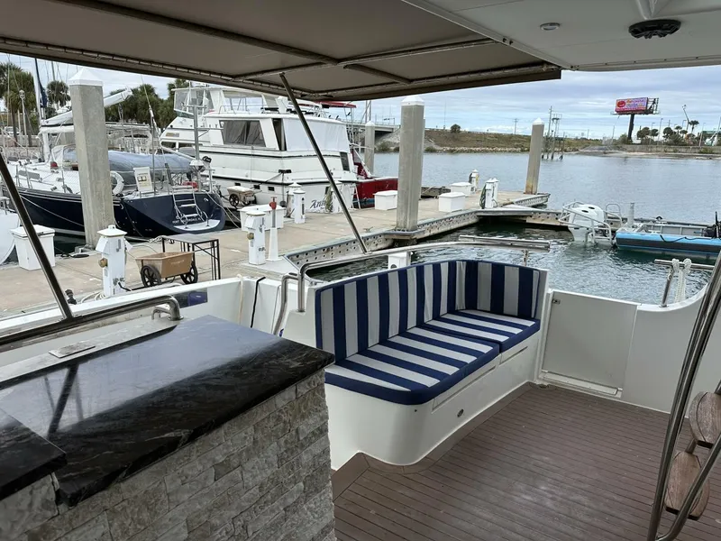 Slide: The Image of Cheoy Lee 72 yacht deck with striped seating, docked at marina, 2004 model. - 7