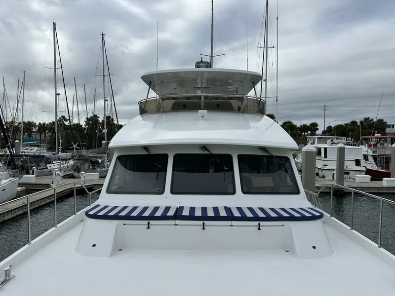 Slide: The Image of 2004 Cheoy Lee 72 yacht docked at marina under cloudy skies. - 8