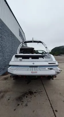 Slide: The Image of 2025 Monterey M-22 boat, rear view, parked on concrete near a building. - 12