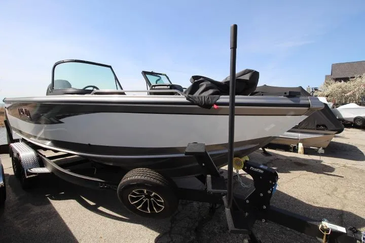 The Image of 2025 Lund 2075 Tyee boat on trailer, parked outdoors under clear sky. - 0
