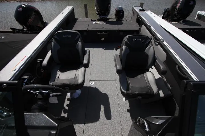 Slide: The Image of 2025 Lund 2075 Tyee boat interior with two seats and steering wheel. - 11