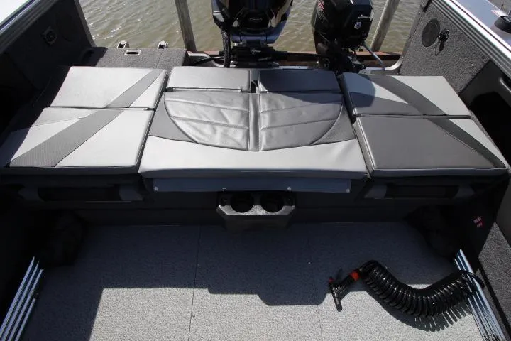 Slide: The Image of 2025 Lund 2075 Tyee boat interior with cushioned seating and storage compartments. - 12