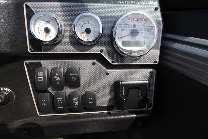 Slide: The Image of Dashboard of a 2025 Lund 2075 Tyee boat with gauges and control switches. - 4