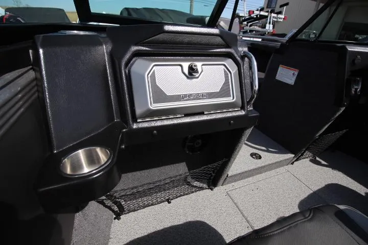 Slide: The Image of 2025 Lund 2075 Tyee boat interior with storage compartment and cup holder. - 5
