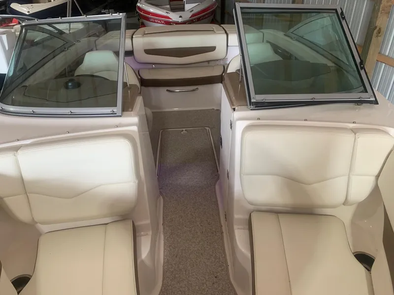 Slide: The Image of 2013 Chaparral 206 SSi boat interior with beige seating and open windshield. - 10