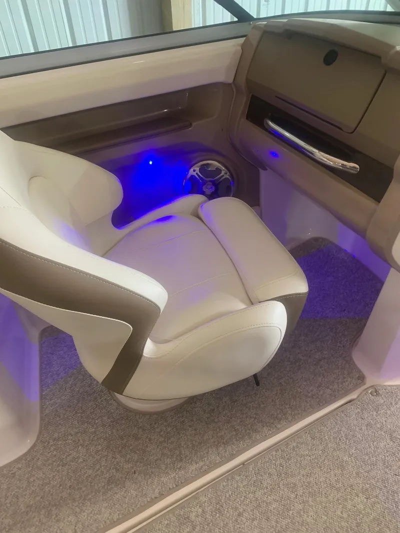 Slide: The Image of 2013 Chaparral 206 SSi boat interior with white seating and blue ambient lighting. - 13