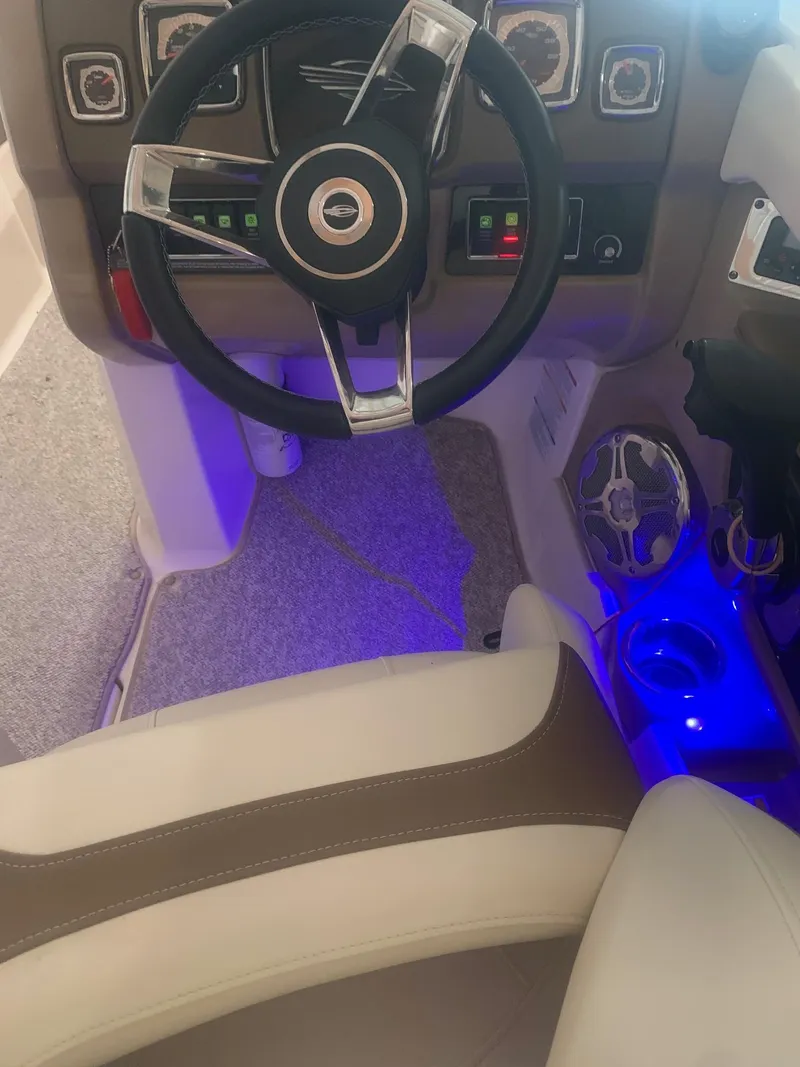 Slide: The Image of Interior of 2013 Chaparral 206 SSi boat with illuminated controls and steering wheel. - 14