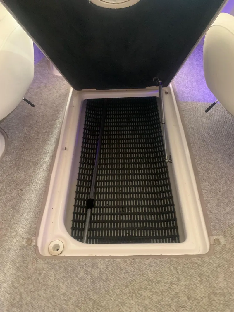 Slide: The Image of Open storage compartment in 2013 Chaparral 206 SSi boat interior. - 15