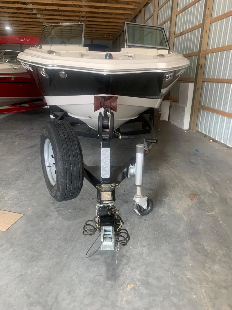 Slide: The Image of 2013 Chaparral 206 SSi boat on trailer in storage facility. - 2