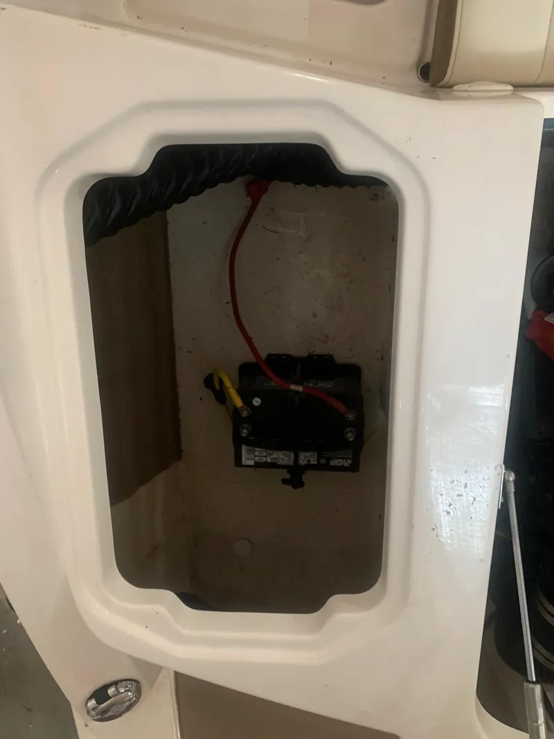 Slide: The Image of Battery compartment of a 2013 Chaparral 206 SSi boat, showing wiring and connections. - 20