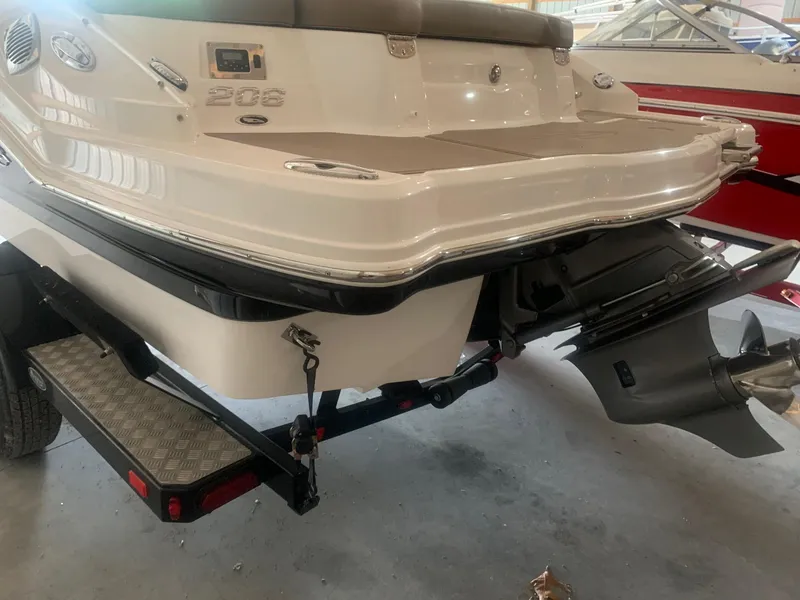 Slide: The Image of 2013 Chaparral 206 SSi boat rear view with outboard motor and trailer. - 3