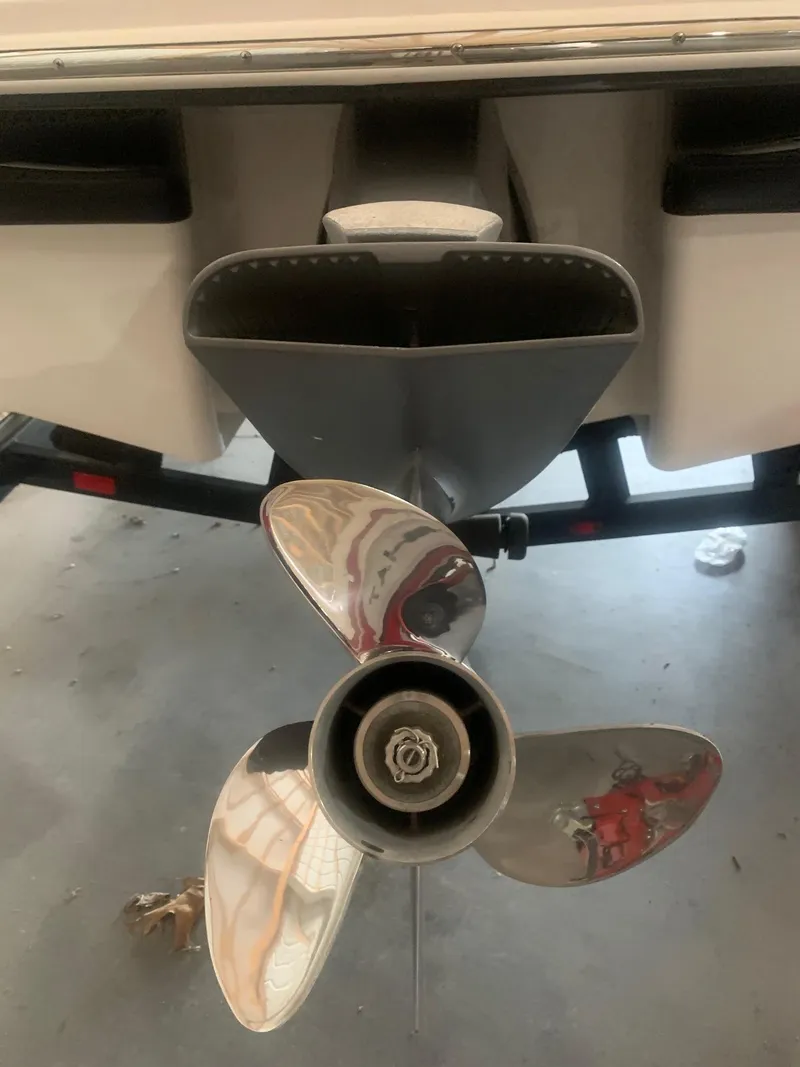 Slide: The Image of 2013 Chaparral 206 SSi boat propeller and stern view in a garage setting. - 4